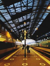 Rear view of people at railroad station