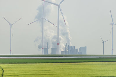 Bonn, germany may 23, 2019. a windmill for electricity production standing in a field along highway