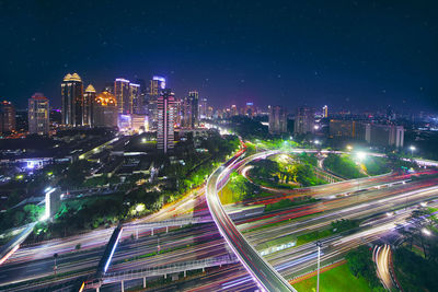 Aerial view of illuminated buildings in city at night