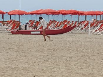 People on beach against sky