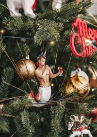 Midsection of woman with christmas tree