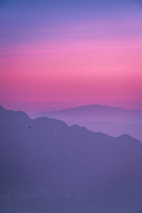 Scenic view of mountains against sky during sunset