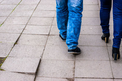 Low section of man walking on footpath