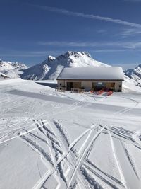 Built structure on snow covered landscape against sky in lech 