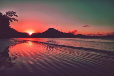 Scenic view of sea against romantic sky at sunset