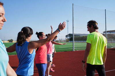 Young women warm up with their coach to start training