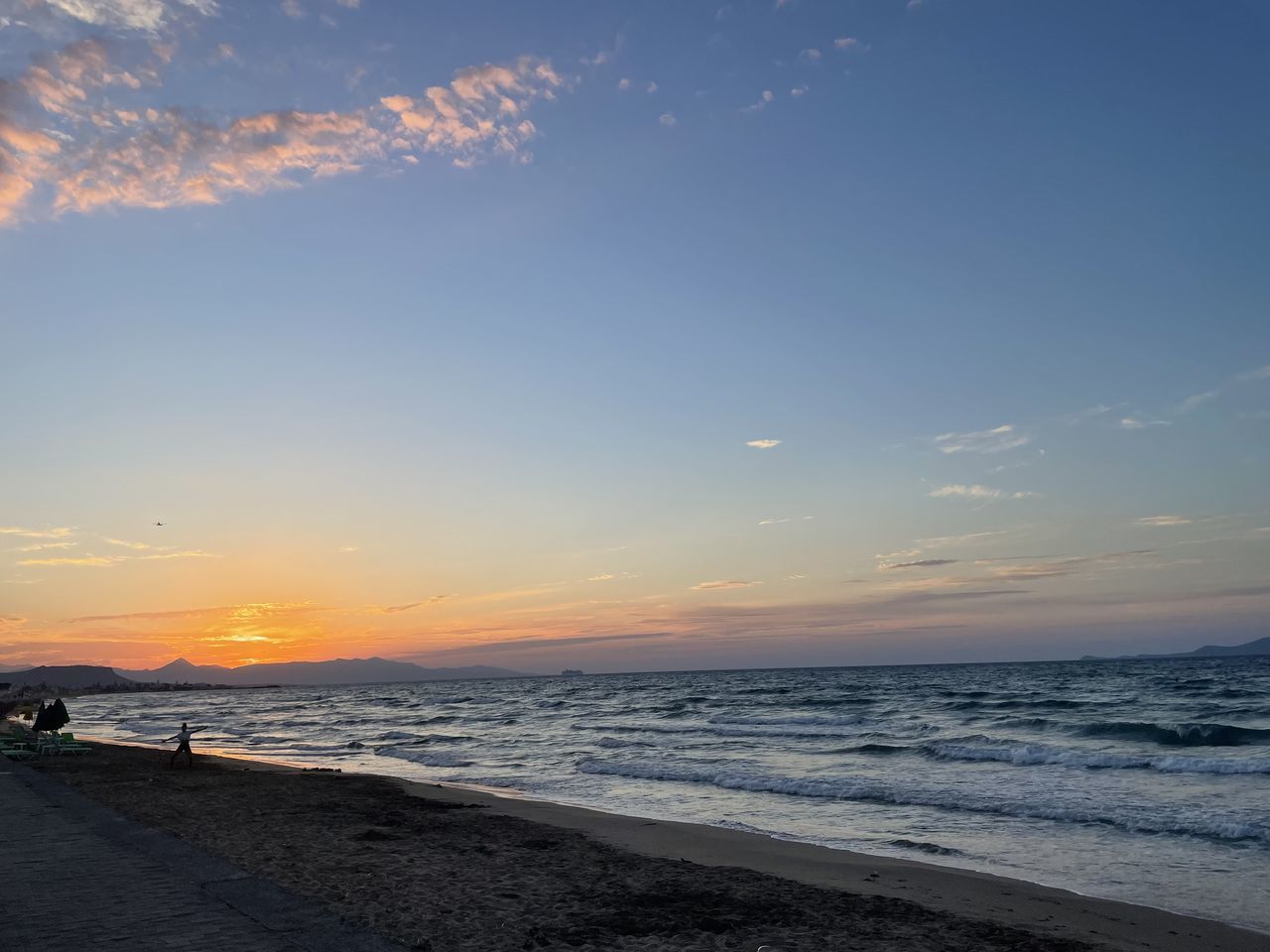 SCENIC VIEW OF BEACH AGAINST SKY AT SUNSET