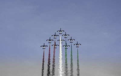 Low angle view of airshow against clear sky