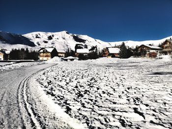 Scenic view of snow covered mountains against clear sky