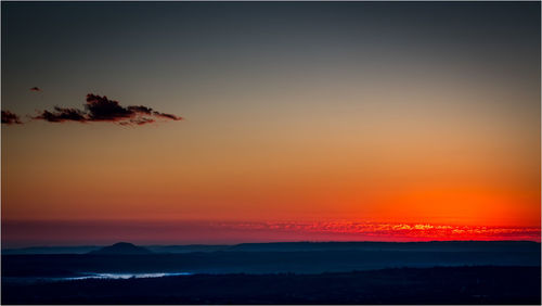 Scenic view of silhouette landscape against romantic sky at sunset