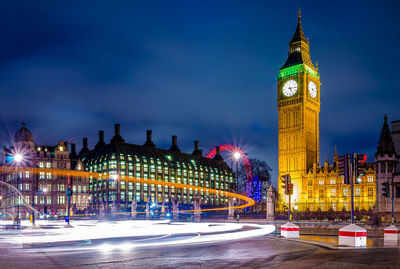 Illuminated clock tower at night