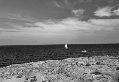 Scenic view of sea against sky and sailingboat