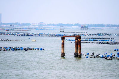 Boats in sea against clear sky