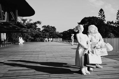 Statue by trees against sky