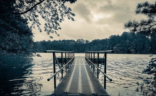 Scenic view of pier on lake against sky