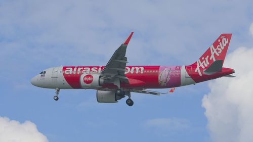 Low angle view of airplane flying against sky