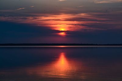 Scenic view of lake against romantic sky at sunset