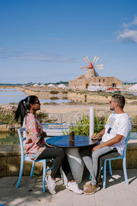 Young couple sitting outdoors