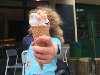 Close-up of hand holding ice cream