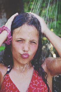 Close-up portrait of girl puckering during shower