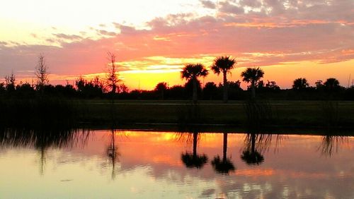Scenic view of lake at sunset