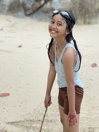 Full length of a smiling young woman on beach pure and innocent