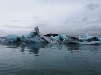 Scenic view of frozen lake against sky