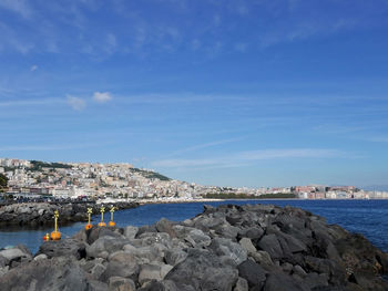 Panoramic view of sea and buildings against sky