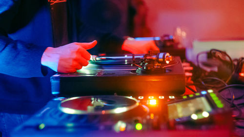 Midsection of man playing music at nightclub