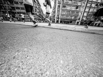 Low section of people walking on road