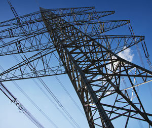 Low angle view of electricity pylon against clear sky