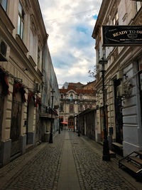 Street amidst buildings against sky