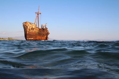 Sailboat on sea against clear sky