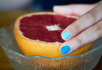 Close-up of hand holding ice grapefruit