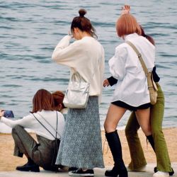 Rear view of women looking at sea