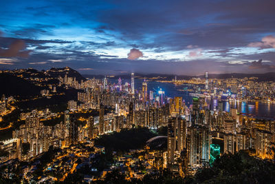 High angle view of illuminated cityscape against sky at night