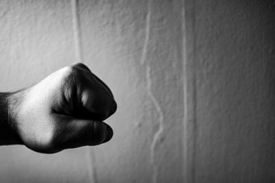 Close-up of man hand on wall