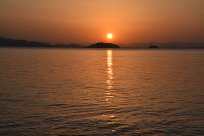 Scenic view of sea against romantic sky at sunset