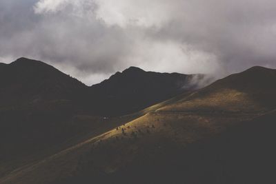 Scenic view of mountains against cloudy sky