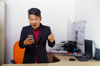 Man using mobile phone in office