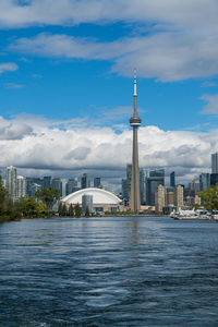 Modern buildings in city against cloudy sky