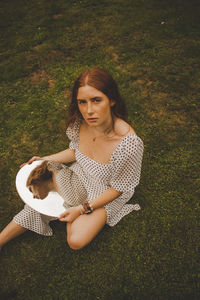 Portrait of young woman on field