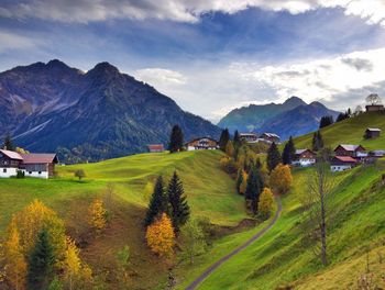 Scenic view of field and mountains against sky