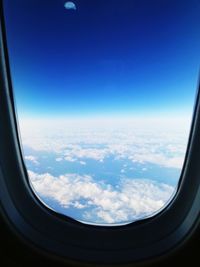 Scenic view of clouds seen through airplane window