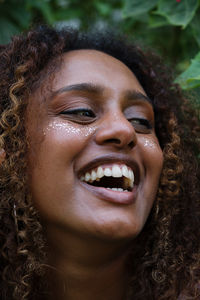 Portrait of a black woman with afro hair and glitter on her face