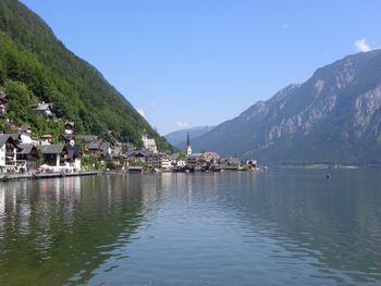 Scenic view of sea and mountains against clear sky