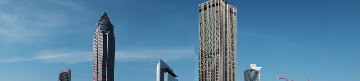 High section of skyscrapers against blue sky