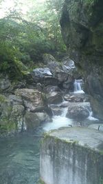 Scenic view of river flowing through rocks