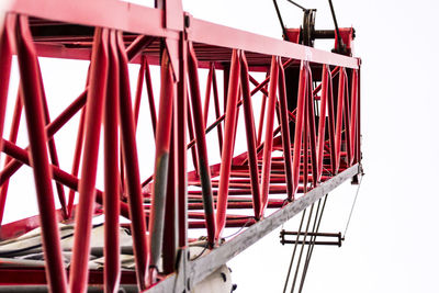 Close-up of red metal structure against sky