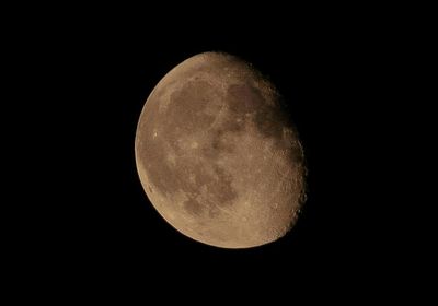 Low angle view of moon over black background